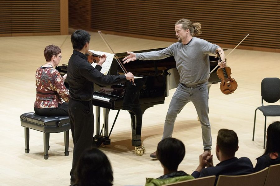 Violinist Christian Tetzlaff, right, works with Andrew Chung in a master class in Bing Concert Hall.